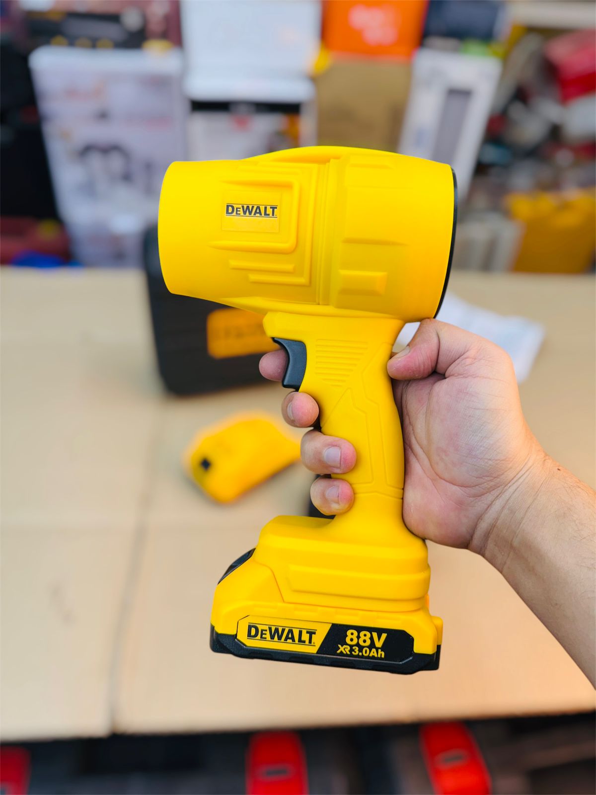 DeWalt cordless drill held by a person with a blurred background