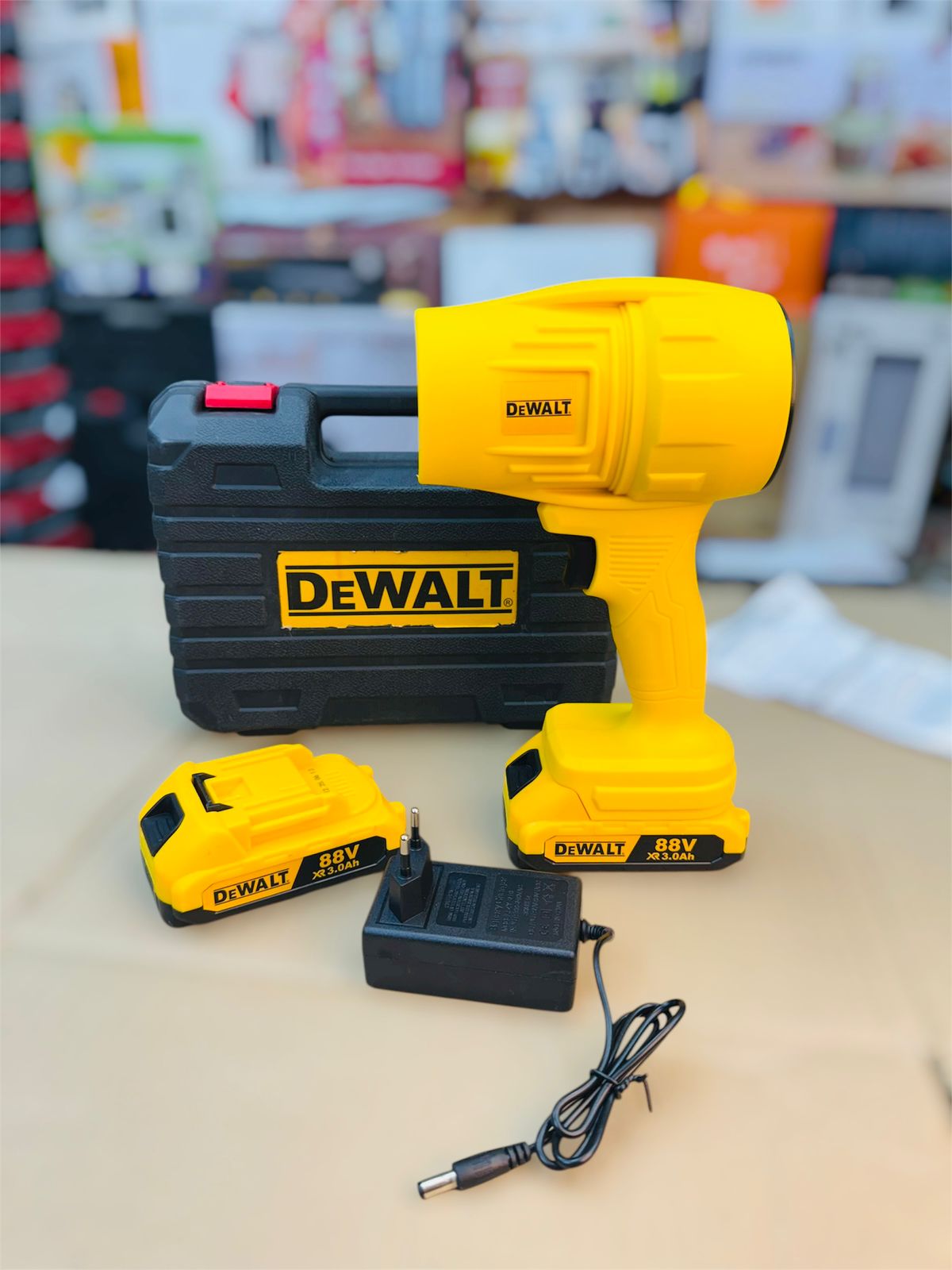 DeWalt power drill set with case, battery, and charger on a light surface.