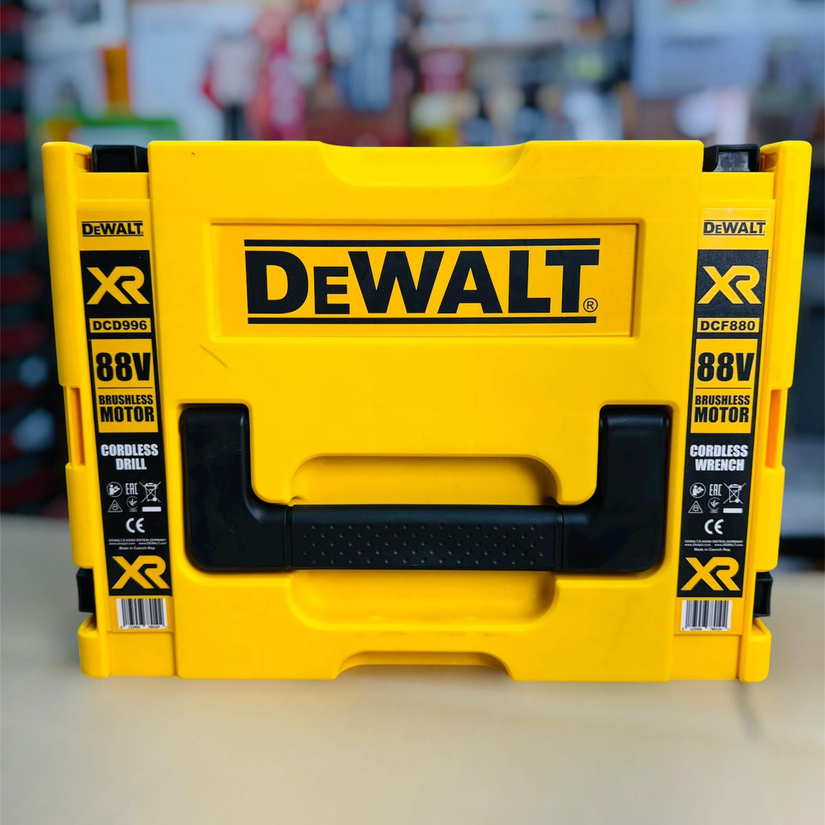 Yellow Dewalt tool case with black handle on a blurred background
