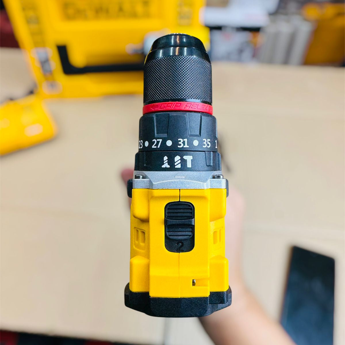 Yellow Dewalt drill with a blurred background